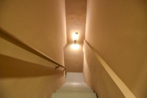 a stairway with a light at the top of it at Two Couples Leisure Art Motel in Tainan