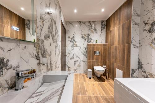 a bathroom with a sink and a toilet at Beluga Guest House in Velingrad