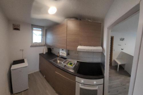 a small kitchen with a sink and a counter top at Messewohnung in Hannover