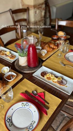 a wooden table with plates of food on it at Locanda Il Sigillo B&B e Ristorante in Rosignano Marittimo