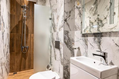 a bathroom with a sink and a shower at Beluga Guest House in Velingrad