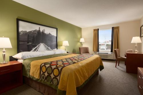 a hotel room with a bed and a window at Super 8 by Wyndham Sherwood Park/Edmonton Area in Sherwood Park