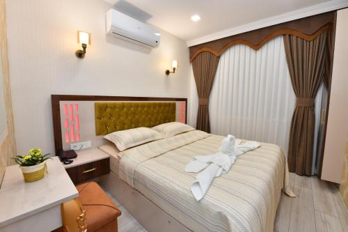 a bedroom with a bed with a white towel on it at Sea Moon Hotel in Istanbul