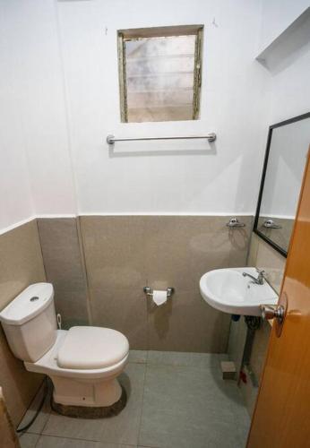 a bathroom with a toilet and a sink at Jungle Studio with terrace in El Nido