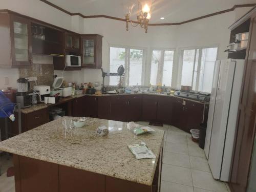 a kitchen with a counter top and a refrigerator at Best Inn Lahug in Cebu City