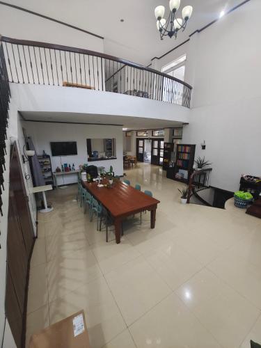 a large living room with a wooden table and chairs at Best Inn Lahug in Cebu City