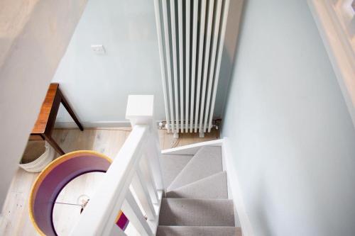 a staircase with a white radiator in a room at The Tractor Shed in Usk