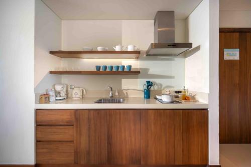 a kitchen with a sink and a counter top at Stunning Apartments Across My Khe Beach ! Rooftop Pool & Gym in Da Nang
