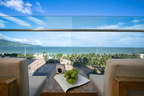 a room with a table with a view of the ocean at Stunning Apartments Across My Khe Beach ! Rooftop Pool & Gym in Da Nang