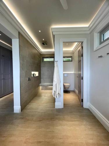 a hallway with a bathroom with a toilet in it at Highend Private Pool Villa in Taling Ngam Beach