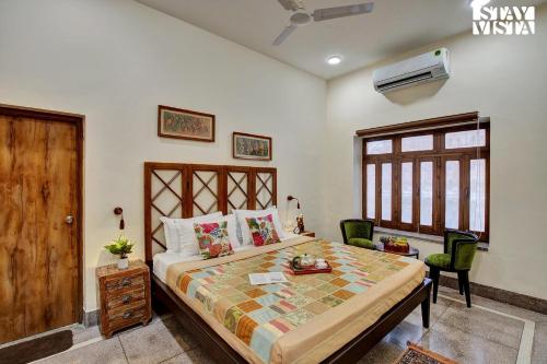 a bedroom with a large bed and a window at StayVista's Madan Villa - City-Center Villa with Manicured Lawn & Picturesque Sit-Outs in Jodhpur