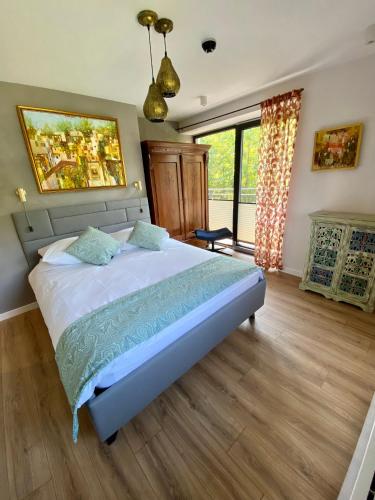 a bedroom with a large bed and a large window at Stara Plebania in Ponice