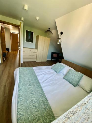 a bedroom with a large bed with two pillows at Stara Plebania in Ponice