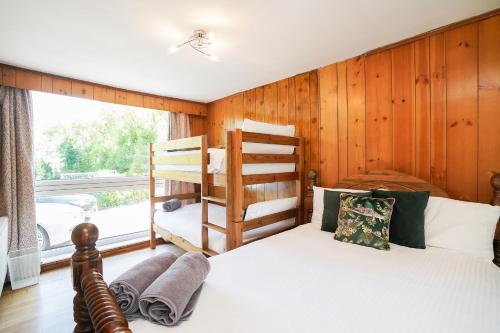 a bedroom with two bunk beds and a window at Spa Home with Pool Sauna Hot Tub Cocktail Bar in Sheffield