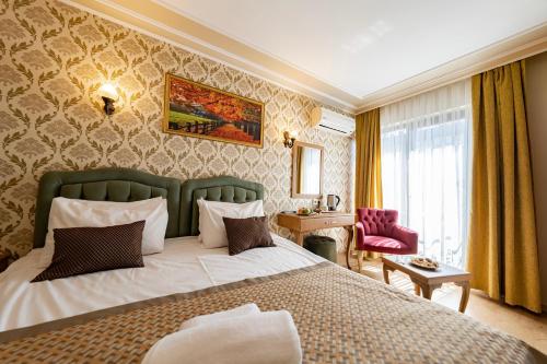 a hotel room with a bed and a chair at Grand Hamit Hotel in Ankara