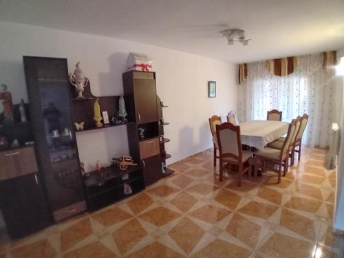 a dining room with a table and chairs at Casa Larisa in Vişeu de Sus