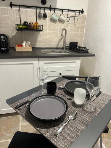 a kitchen with a table with two plates and wine glasses at Cantovì in Bari