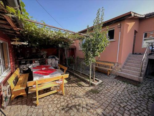 a house with a table and a tree in front of it at Tainov House in Samokov