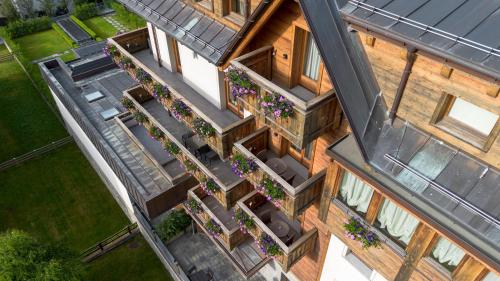 an overhead view of a house with a balcony with flowers at Sottovento Luxury Hospitality in Bormio