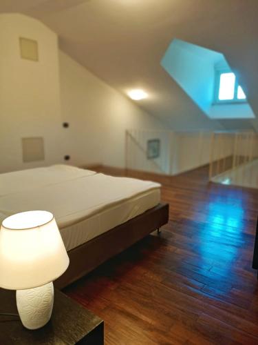 a bedroom with a bed and a lamp on a table at Aquazzurra Resort & Aparthotel in Cannobio