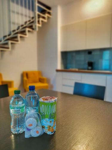 a table with two bottles of water and a can of milk at Aquazzurra Resort & Aparthotel in Cannobio