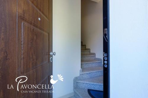 a door leading to a stairway with a stair case at Case Vacanze La Pavoncella in Teulada