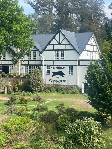 a large white house with a sign on it at The Historic Hogsback Inn in Hogsback