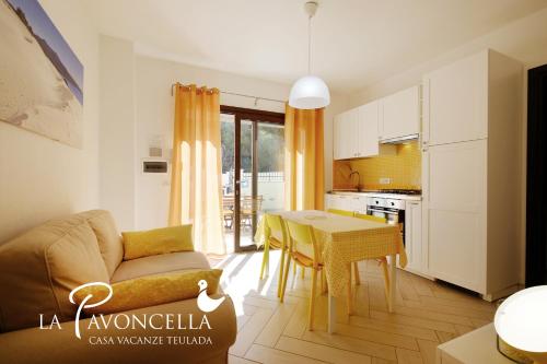 a living room with a couch and a table at Case Vacanze La Pavoncella in Teulada