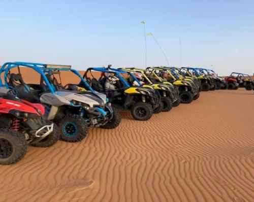 a row of atvs parked in the desert at Desert Berber Fire Camp in Merzouga