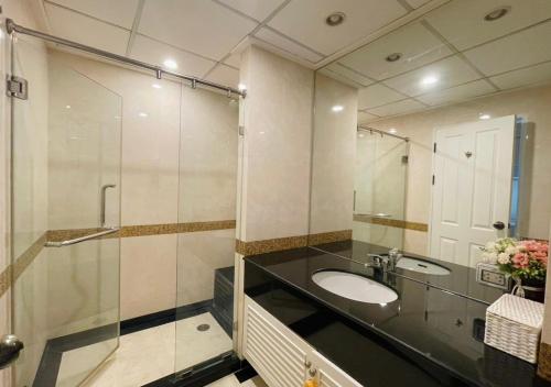 a bathroom with a sink and a shower at Supalai Oriental Place in Bangkok