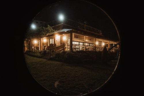 a building at night with lights in front of it at Cabañas de Lires in Lires
