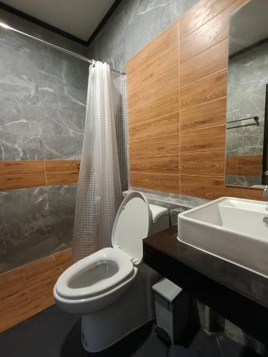 a bathroom with a toilet and a sink at Lanta Chaolay in Ko Lanta