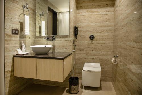 a bathroom with a sink and a toilet at Hotel Rajmahal in Guwahati