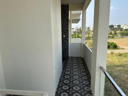 a hallway of a house with a tile floor at DEEYA Guest House - A Luxury Home Stay in Mysore
