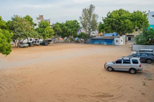 a car parked in the middle of a dirt field at HOTEL NATCHATHRA in Rāmeswaram