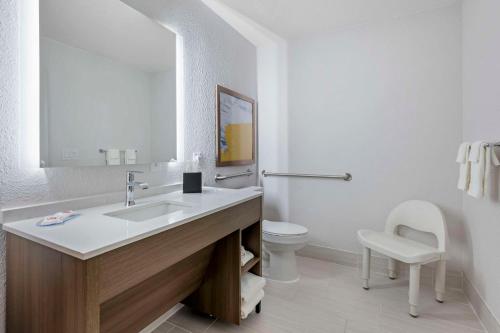 a white bathroom with a sink and a toilet at Comfort Suites West Indianapolis - Brownsburg in Brownsburg