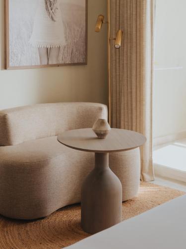 a living room with a table and a couch at Hyde Ibiza in Cala Llonga