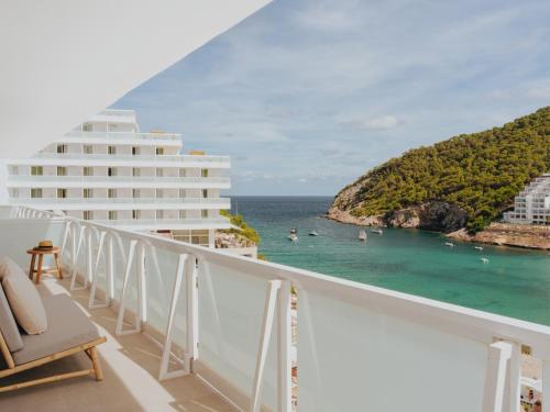 a view of the ocean from the balcony of a resort at Hyde Ibiza in Cala Llonga