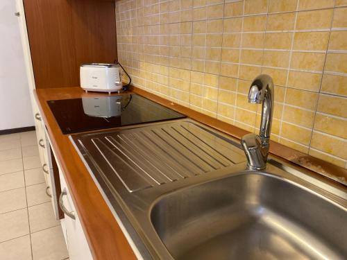 a kitchen with a sink and a toaster on a counter at Casa Barnabei 26 in Teramo