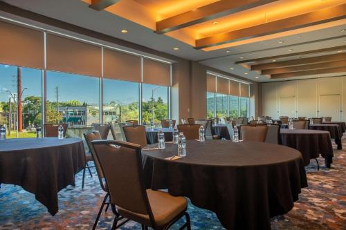 a conference room with tables and chairs and large windows at DoubleTree by Hilton Asheville Downtown in Asheville