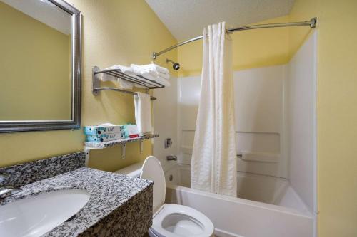 a bathroom with a sink and a toilet and a shower at Econo Lodge Spotsylvania Town Center in Fredericksburg