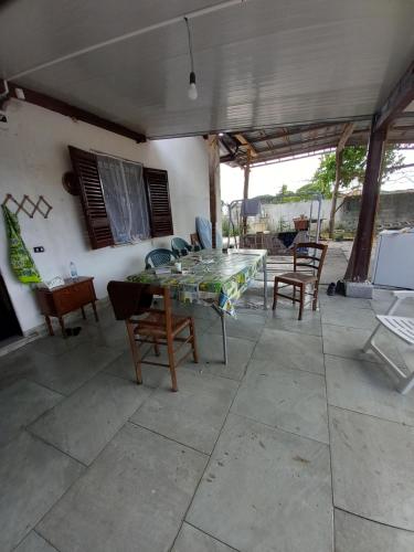 a patio with a table and chairs on a patio at Casa tiziana in Terracina