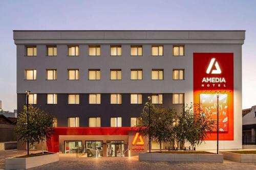 a large building with aania sign in front of it at Amedia Milano, Trademark Collection by Wyndham in Milan
