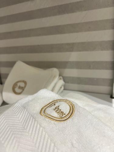 a white towel with the word mum on it on a bed at Enzo rooms & apartment Blloku in Tirana