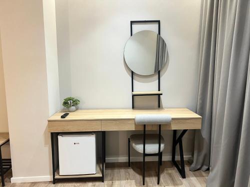 a dressing table with a mirror and a stool at Enzo rooms & apartment Blloku in Tirana