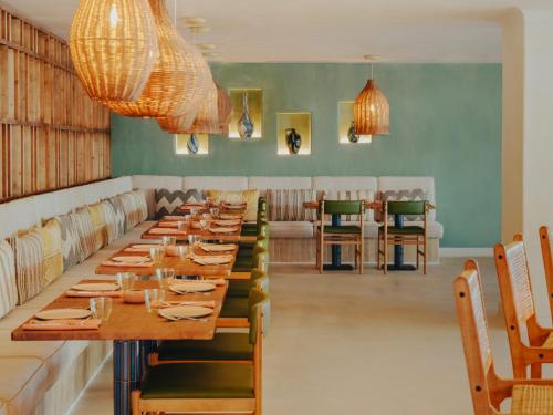 a dining room with a long table and chairs at Hyde Ibiza in Cala Llonga