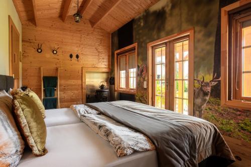 a bedroom with a bed in a log cabin at Hubertus Dwór Myśliwski in Opole