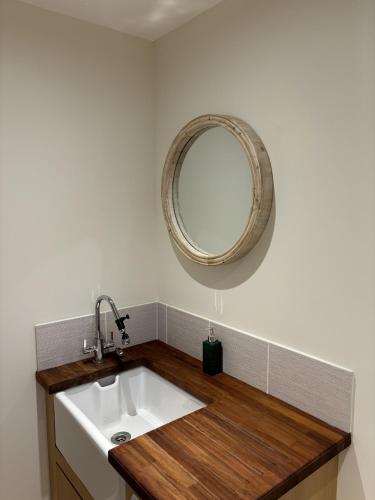 a bathroom with a sink and a mirror on the wall at The Heathers in Killin