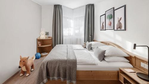 a bedroom with a large bed and a desk at Lisi Family Hotel in Reith bei Kitzbühel