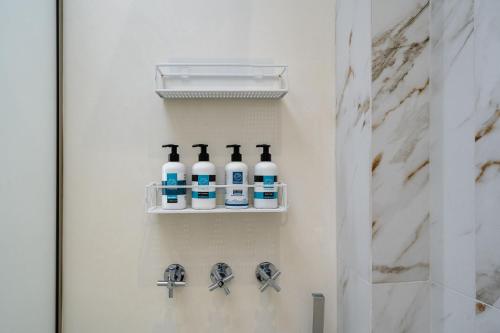 a bathroom with bottles ofivedivedivedivedivedivedivedivedivedivedived at Infinity View Apartment in Naxos Chora
